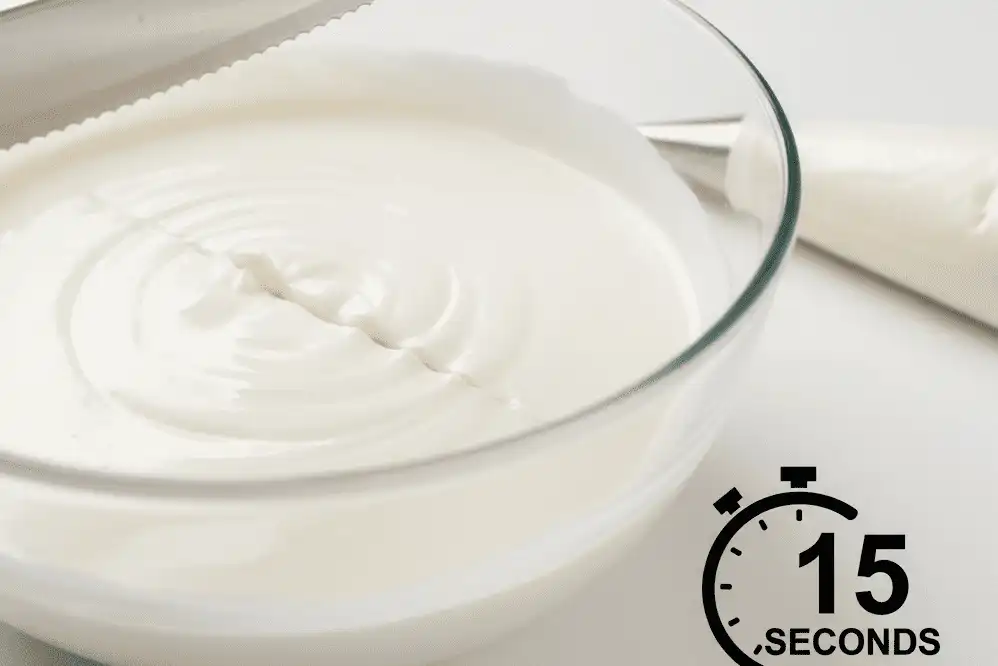 Demonstrating the 15-second icing consistency test in a mixing bowl
